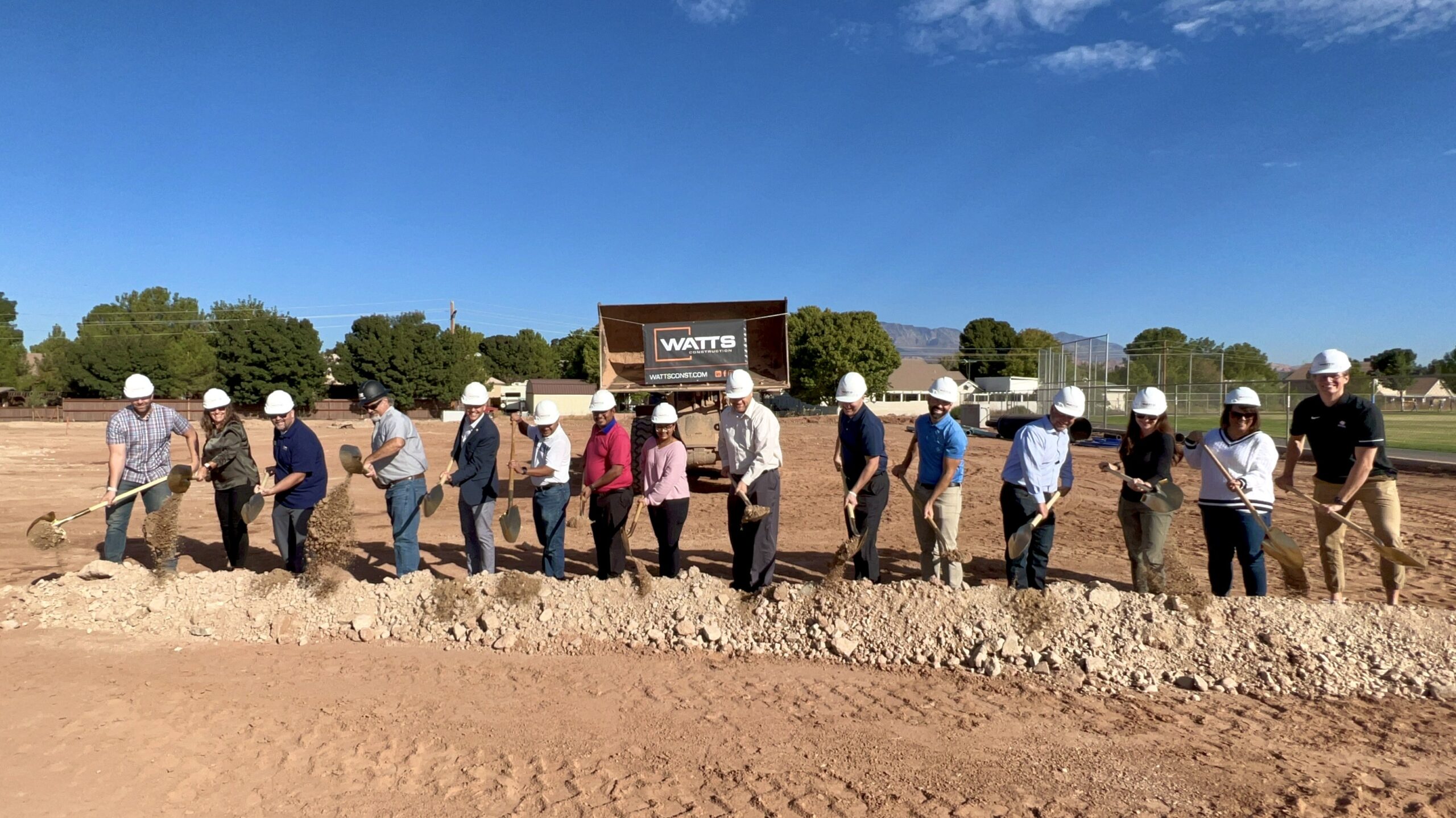 Watts representatives, the architect, owners, Mayor Staheli, and others from the community turn the dirt with gold shovels