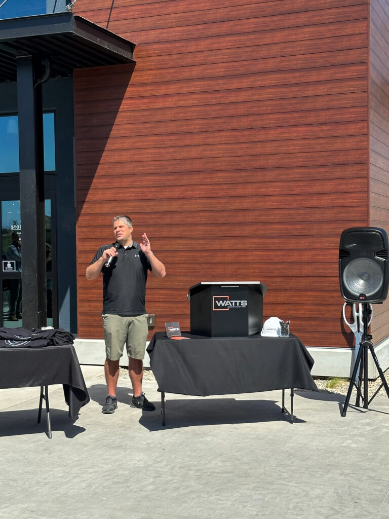 Jason Larsen speaking at the podium